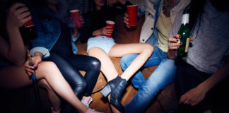 How are underage drinkers influenced by alcohol ads?